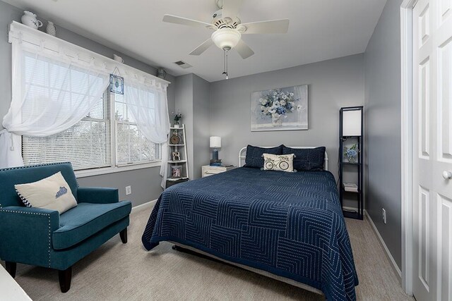 bedroom with visible vents, ceiling fan, baseboards, and carpet