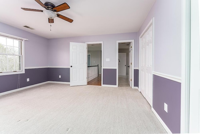 unfurnished bedroom with baseboards, visible vents, carpet floors, and a closet