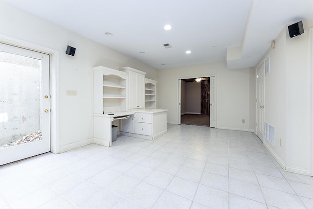 interior space featuring recessed lighting, visible vents, baseboards, and built in desk