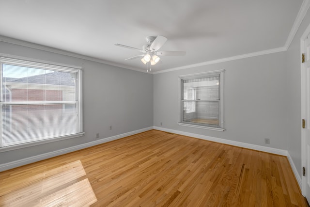 unfurnished room with light wood-type flooring, crown molding, baseboards, and a ceiling fan