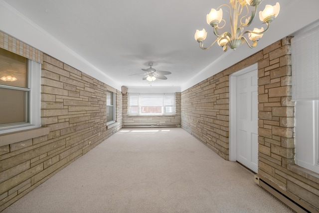 spare room featuring a baseboard radiator, carpet floors, and ceiling fan with notable chandelier