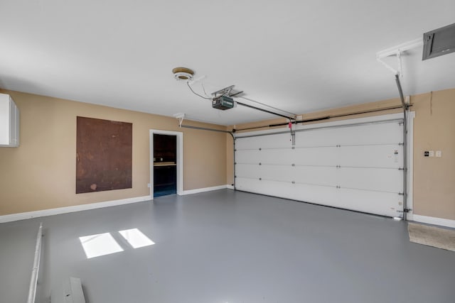 garage featuring a garage door opener and baseboards