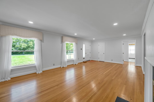 unfurnished living room with recessed lighting, crown molding, light wood-type flooring, and baseboards