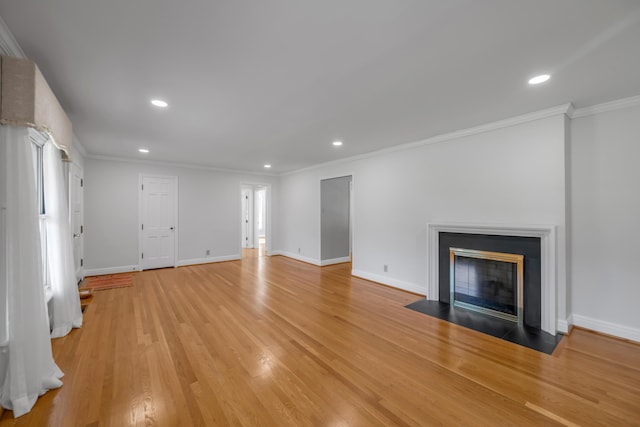 unfurnished living room with recessed lighting, baseboards, crown molding, and light wood finished floors