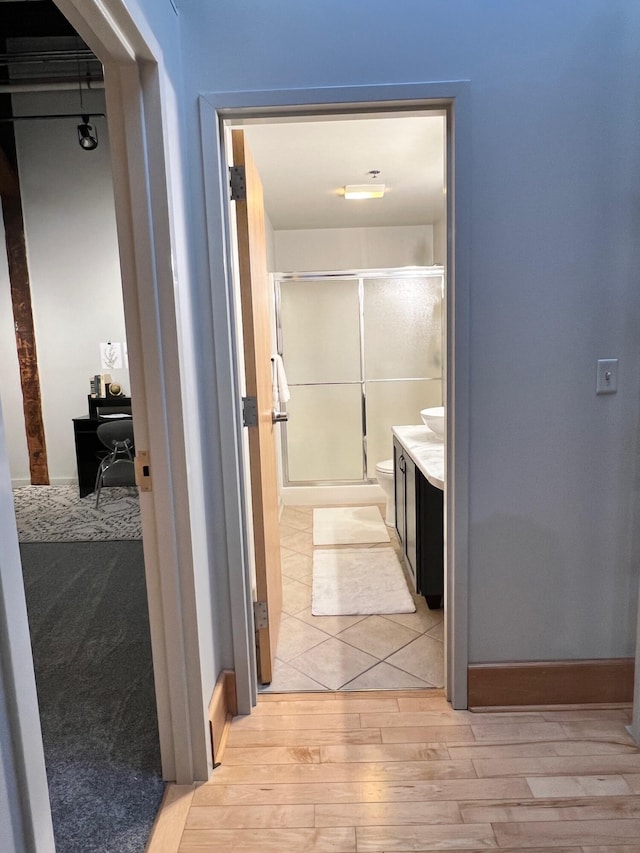 hallway with light wood-style floors