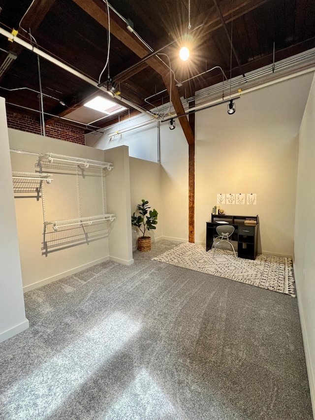 basement featuring carpet flooring and baseboards