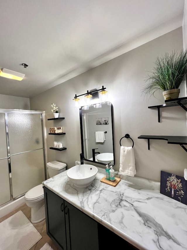 bathroom with vanity, toilet, and a shower stall
