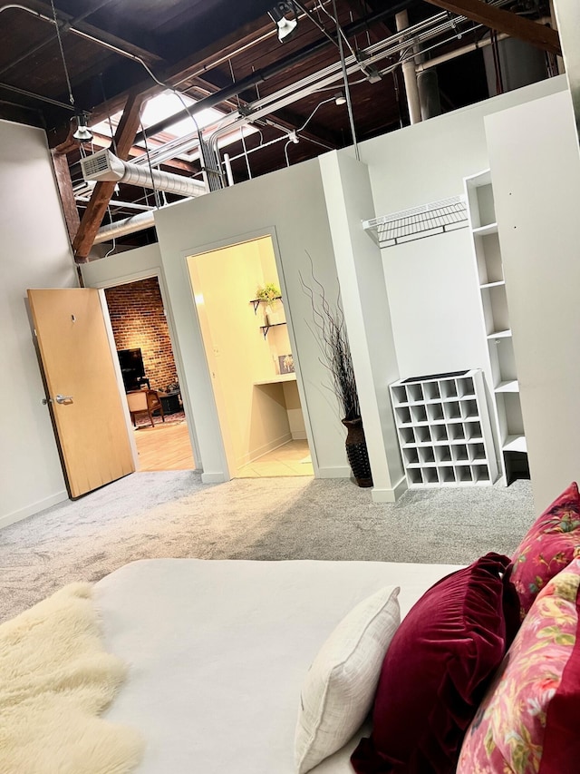 carpeted bedroom with visible vents, ensuite bathroom, and baseboards