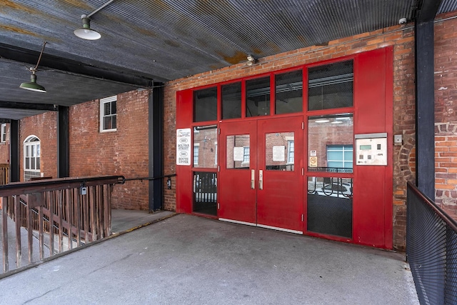view of exterior entry featuring brick siding