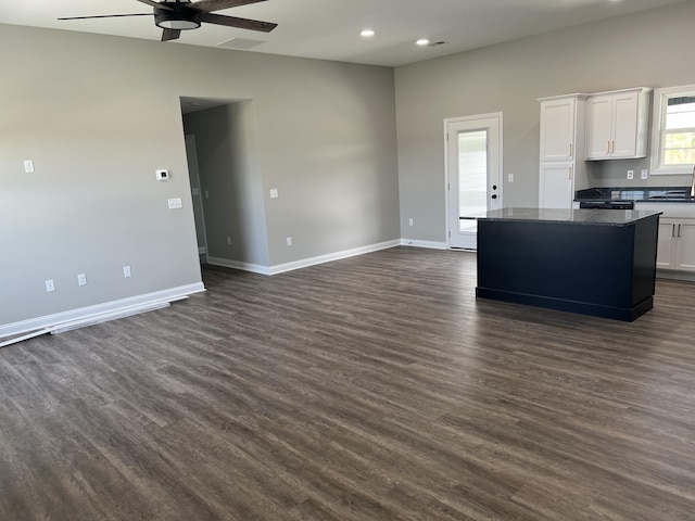 kitchen featuring white cabinets, a center island, dark wood finished floors, recessed lighting, and ceiling fan