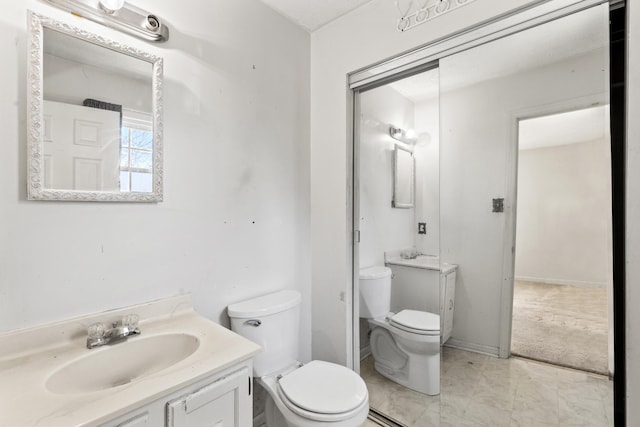 bathroom featuring toilet and vanity