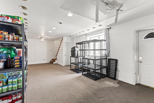 basement featuring stairway, baseboards, carpet floors, and recessed lighting