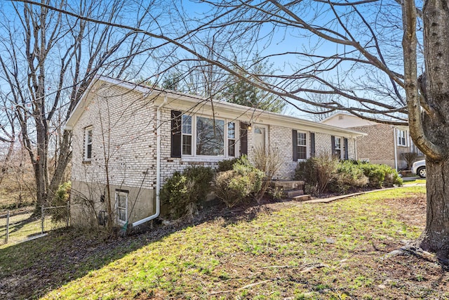 ranch-style house featuring fence and a front yard