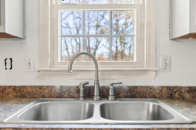 room details featuring dark countertops and a sink