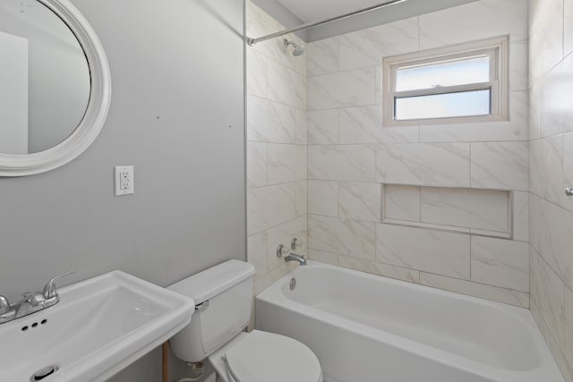 bathroom with shower / washtub combination, toilet, and a sink