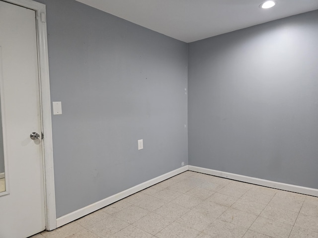 spare room featuring tile patterned floors, recessed lighting, and baseboards
