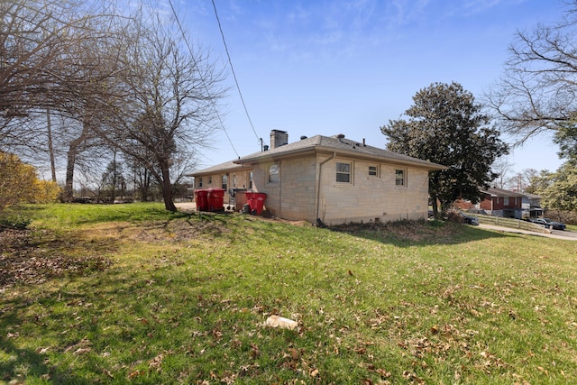 exterior space with a lawn and a chimney