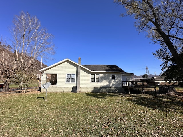 back of property featuring a lawn