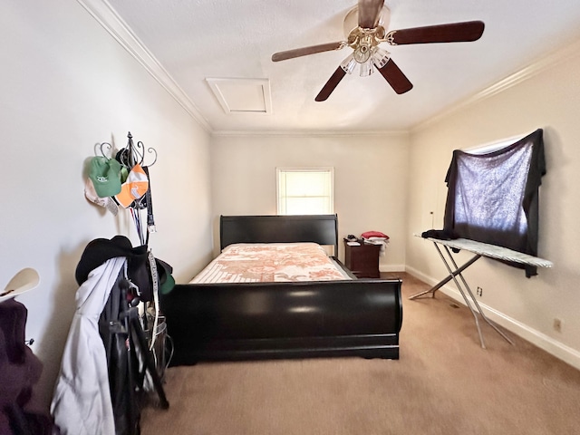 bedroom featuring a ceiling fan, carpet, baseboards, attic access, and crown molding