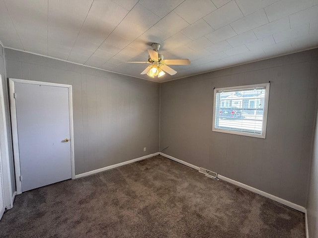 unfurnished room with baseboards, carpet flooring, a ceiling fan, and visible vents