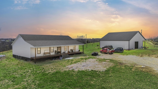 700 Nick Ln, Winchester, KY 40391 - back of house at dusk with a shingled roof, a pole building, a porch, a yard, and an outdoor structure