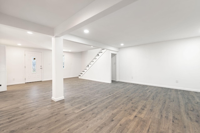 finished basement with baseboards, recessed lighting, wood finished floors, and stairs
