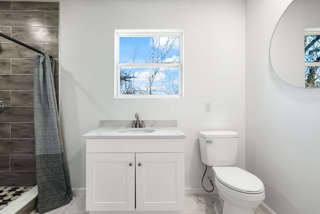 full bathroom featuring tiled shower, vanity, toilet, marble finish floor, and baseboards