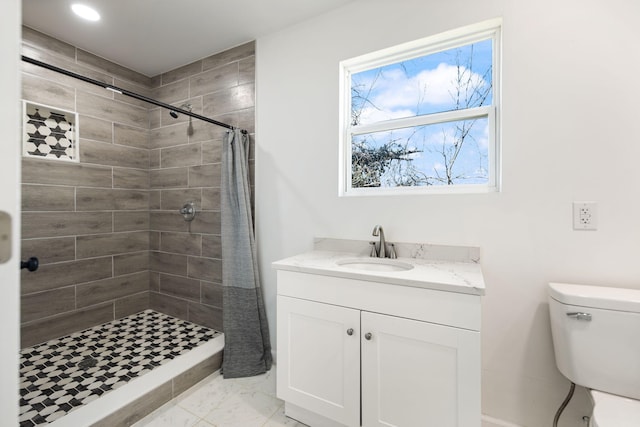 bathroom with toilet, tiled shower, marble finish floor, and vanity