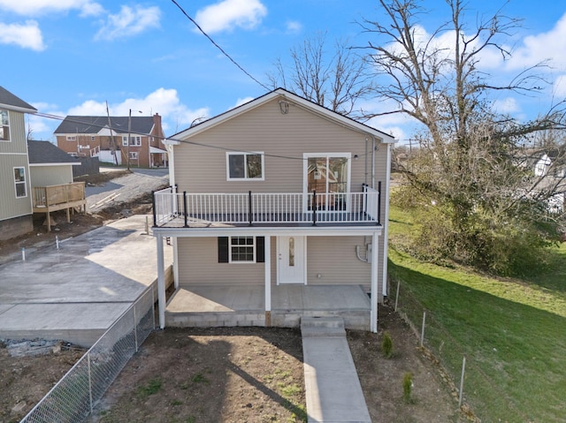 back of house featuring a yard and fence