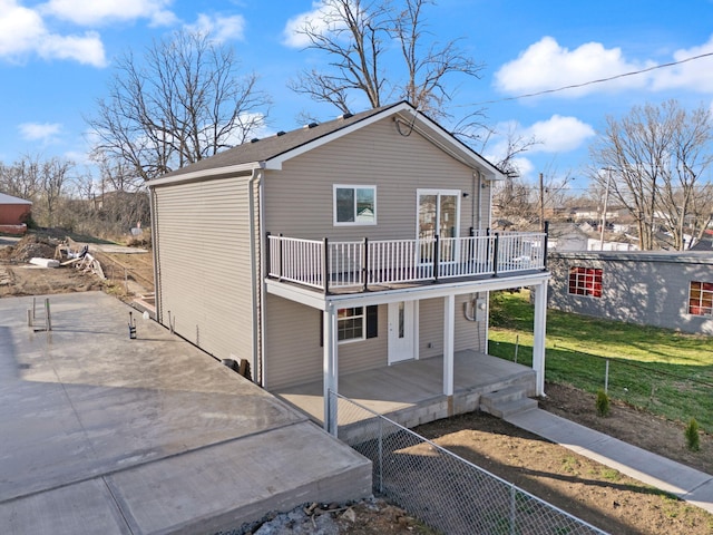 rear view of house with a lawn and covered porch