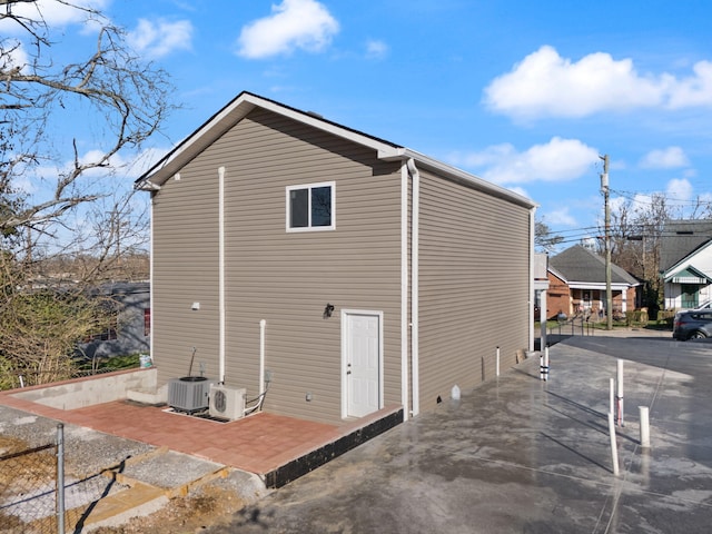 rear view of property with ac unit