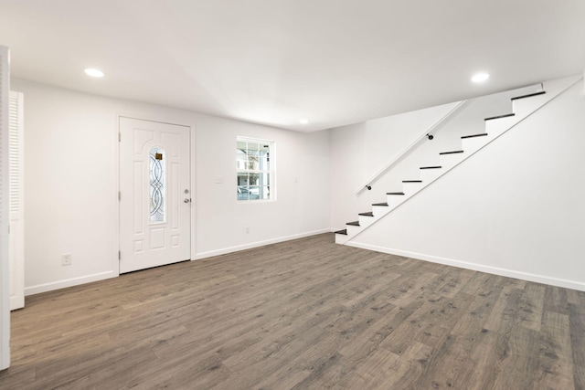 entryway with wood finished floors, recessed lighting, baseboards, and stairway