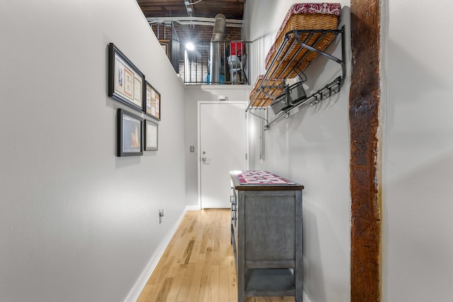 interior space featuring wood-type flooring and baseboards