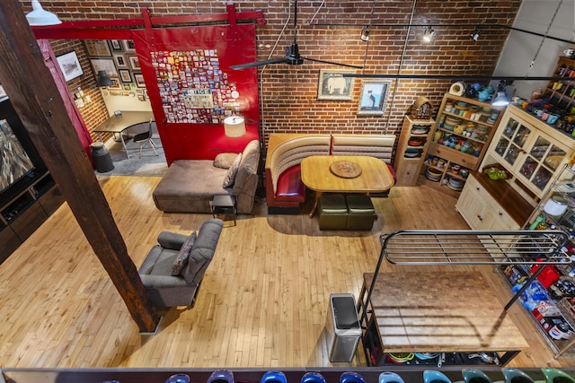 living room featuring brick wall and hardwood / wood-style floors