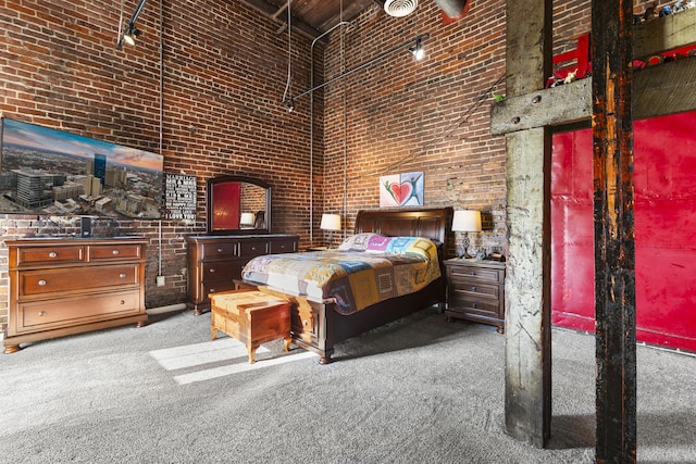 carpeted bedroom featuring a towering ceiling