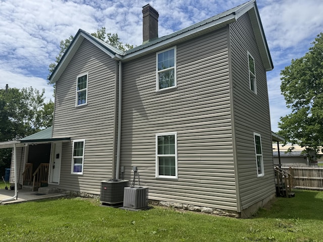 104 First St, Cynthiana, KY 41031 - rear view of property featuring a chimney, a patio, central AC unit, and entry steps