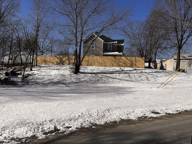 104 First St, Cynthiana, KY 41031 - view of snow covered exterior featuring a chimney
