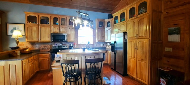 2619 County Farm Rd, London, KY 40741 - kitchen featuring stainless steel appliances, dark wood finished floors, decorative backsplash, a kitchen island, and glass insert cabinets