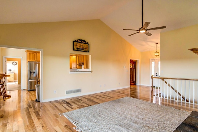 1794 Hunter Dr, Lancaster, KY 40444 - unfurnished living room with ceiling fan, high vaulted ceiling, light wood-style flooring, and baseboards