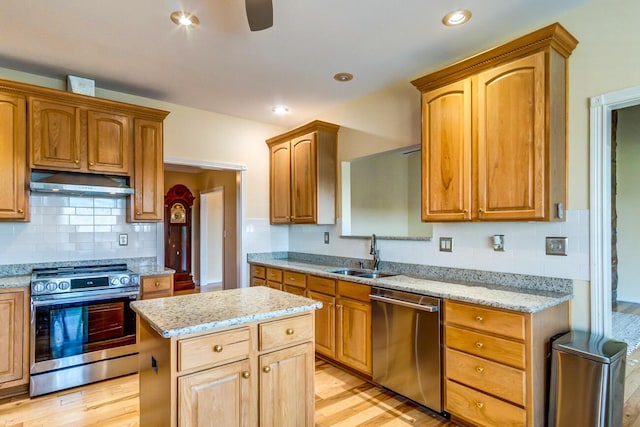 1794 Hunter Dr, Lancaster, KY 40444 - kitchen with stainless steel appliances, a sink, under cabinet range hood, light wood-style floors, and light stone countertops