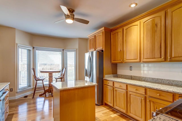 1794 Hunter Dr, Lancaster, KY 40444 - kitchen with stainless steel fridge with ice dispenser, light stone counters, light wood finished floors, ceiling fan, and recessed lighting