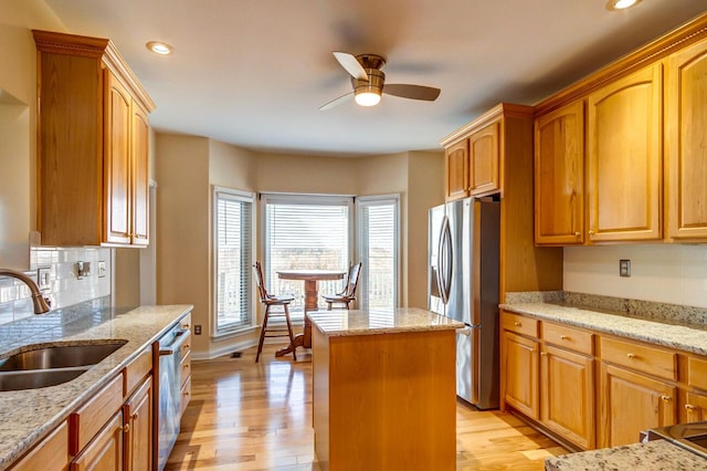 1794 Hunter Dr, Lancaster, KY 40444 - kitchen featuring stainless steel appliances, a sink, a kitchen island, ceiling fan, and light wood-style floors