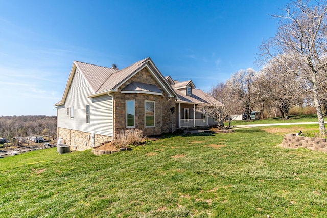 1794 Hunter Dr, Lancaster, KY 40444 - view of front facade with stone siding, a front lawn, metal roof, and central AC unit
