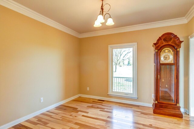 1794 Hunter Dr, Lancaster, KY 40444 - empty room featuring light wood-style flooring, a chandelier, ornamental molding, and baseboards