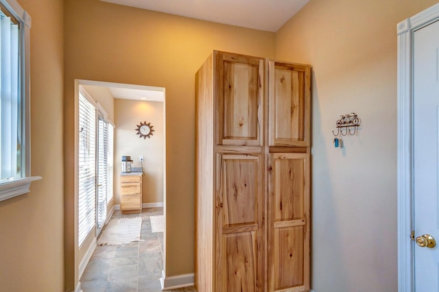 1794 Hunter Dr, Lancaster, KY 40444 - hall featuring healthy amount of natural light, stone finish flooring, and baseboards