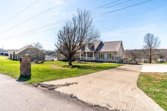 1794 Hunter Dr, Lancaster, KY 40444 - view of front facade featuring concrete driveway, a front lawn, and metal roof