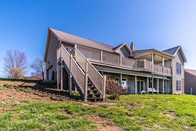 1794 Hunter Dr, Lancaster, KY 40444 - back of property with a chimney, metal roof, a wooden deck, and a lawn