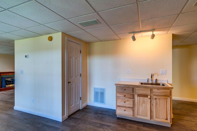 1794 Hunter Dr, Lancaster, KY 40444 - bar area featuring a sink, baseboards, dark wood-style floors, a drop ceiling, and track lighting