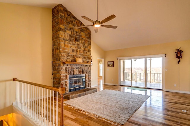 1794 Hunter Dr, Lancaster, KY 40444 - living room featuring a ceiling fan, wood finished floors, high vaulted ceiling, a stone fireplace, and baseboards