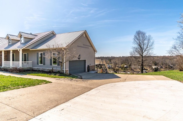 1794 Hunter Dr, Lancaster, KY 40444 - view of home's exterior with concrete driveway, covered porch, metal roof, and a garage